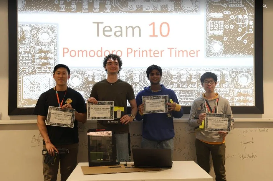 Team 10 hold their certificates in front of their Pomodoro Printer Timer slide