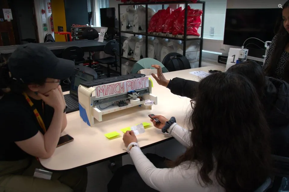 A repurposed printer labelled “MATCH POINT” being tested on a workbench